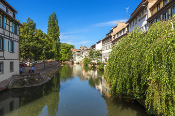 Fototapeta na wymiar Strasbourg, France. The picturesque river flow in the region of Ile quarter 