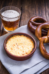 Hot cheese fondue with pretzel