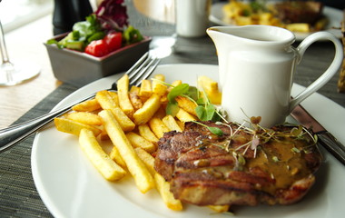 beef steak with french fried in white plate