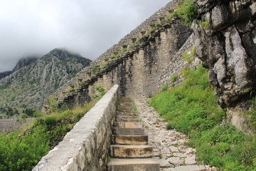 Fototapeta na wymiar A long stone staircase with high steps rising up to the clouds