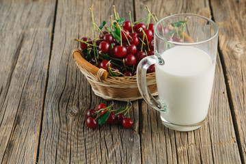 Red sweet cherries with glass of milk
