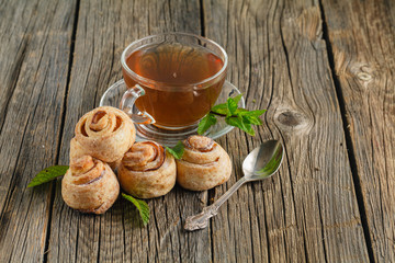 Sweet bun with chocolate and cup of tea