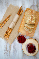 Obraz na płótnie Canvas Wine, bread and wheat on the wooden table