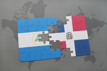 puzzle with the national flag of nicaragua and dominican republic on a world map background.