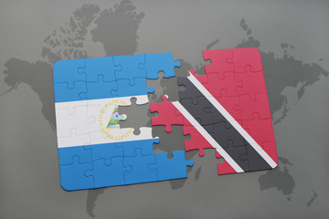puzzle with the national flag of nicaragua and trinidad and tobago on a world map background.
