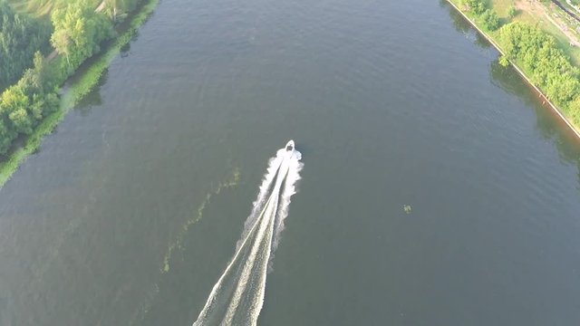 Aerial tilt shot of a speedboat cruising along the Moscow river