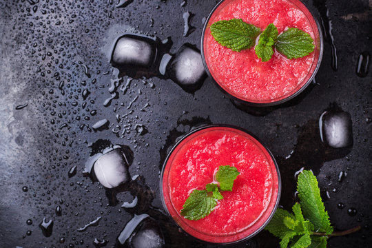 Watermelon red drink with mint on a grunge table