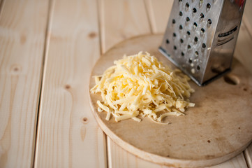 grated cheese on a wooden board
