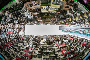 Hong Kong - May 31, 2015 :  Back of crowded buildings stand  surrounded the small common area, shooting in vertical view compares with modern building in  Hong Kong.