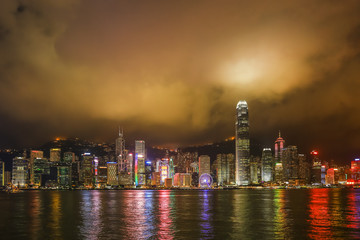 Hong Kong night view  with reflections of light on the cloud at victoria harbor