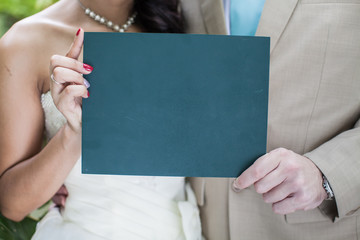 Bride and Groom holding small blackboard with message Just Marri