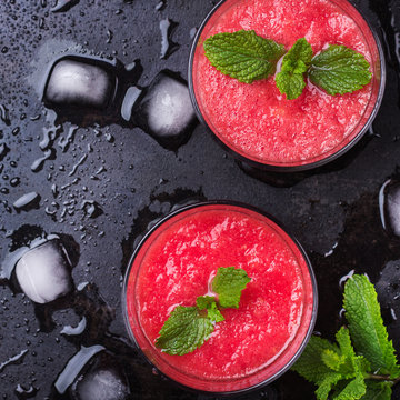 Watermelon red drink with mint on a grunge table