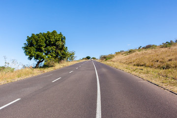 Road uphill blue sky travel countryside destination.