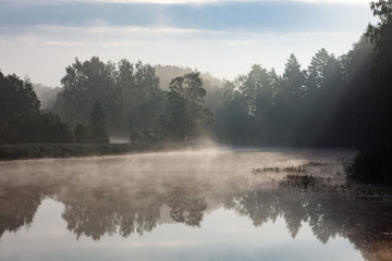 Fototapeta na wymiar Foggy summer morning on the river