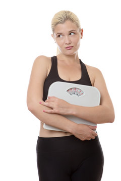woman holding weight scales
