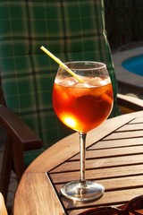 Cold summer drink by the pool. Party with refreshments by the pool. Alcohol drink with ice. Glasses with a refreshing drink. Alcohol at the party.
