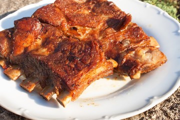 Grilled pork ribs on the grill. Marinated Grilled ribs on a summer party. Evening at a party. 
