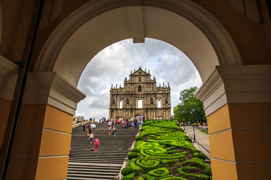 Macau, China - Jun 1, 2015 : Tourists are taking pictures at the Ruins of St. Paul Cathedral during the raining day.
