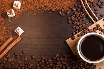 Cup of coffee, coffee beans, ground coffee and sugar 