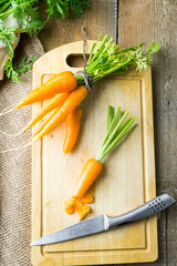 Bunch of fresh carrot on cutting board