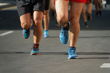 Marathon running race, people feet on city road