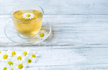 Chamomile tea on wooden background