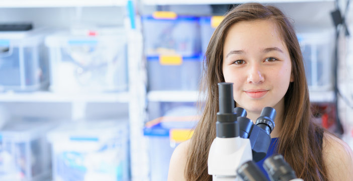 Teen girl in laboratory classes, banner horizontal format with free copyspace