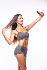 Young trained athlete girl take selfie from phone