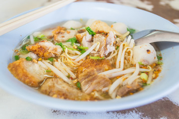 Thai Tomyum noodle with streaky pork, vegetable and balls