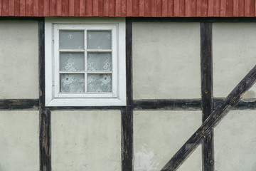 Timber frame wall with window and red roof