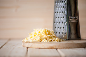 grated cheese on a wooden board