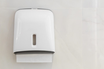 Soft focus tissues paper towel dispenser on granite wall