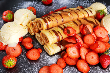 Sweet Rolled Pancakes with nutella, strawberry and ice cream.