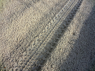 SUV wheel trace on the desert road after the rain in the Western Kazakhstan