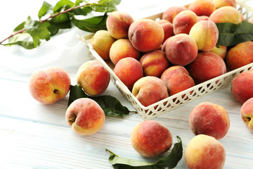 Fototapeta na wymiar Sweet peach fruit in tray on white wooden table
