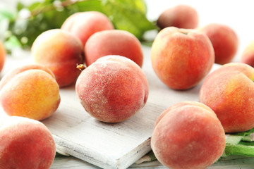 Sweet peach fruit on white wooden table