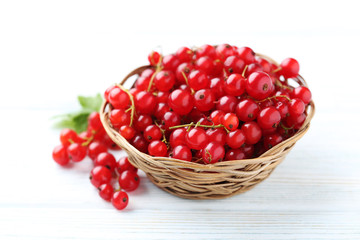 Red currant on a white wooden table