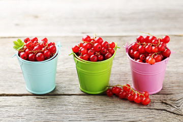 Red currant on a grey wooden table