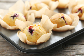 Muffins with blueberries on grey wooden table