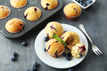 Muffins with blueberries on a grey table