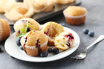 Muffins with blueberries on a grey table