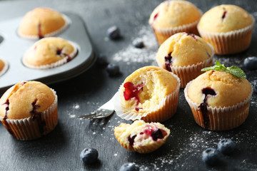 Muffins with blueberries on a grey table