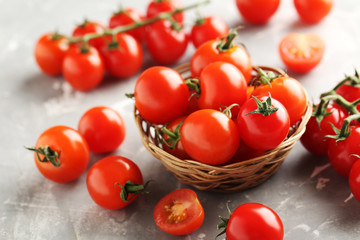 Cherry tomatoes branch on a grey background