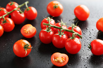 Cherry tomatoes branch on a black background
