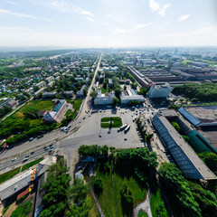 Fototapeta premium Aerial city view with crossroads and roads, houses, buildings, parks and parking lots, bridges. Copter shot. Panoramic image.