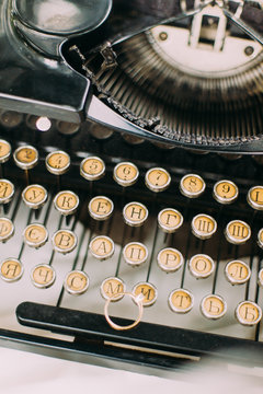 Retro toned vintage typewriter keys detail, close up with selective focus, top view