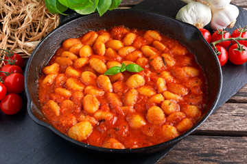 Homemade Italian Gnocchi with marinara sauce in iron pan