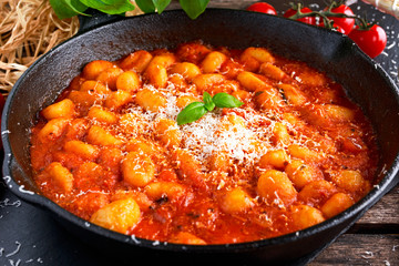 Homemade Italian Gnocchi with marinara sauce, cheese in iron pan