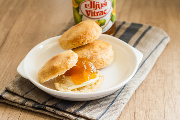 scones with butter and jam on a napkin and Bank of jam