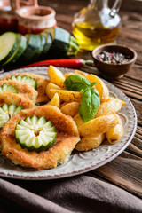 Breaded fried zucchini with American potatoes and cucumber